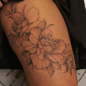 Elegant blackwork and illustrative style flower design on upper arm by talented artist Yura.