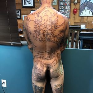 Get a stunning illustrative Japanese dragon tattoo on your back by the talented artist Ami James. A legendary symbol of power and strength.