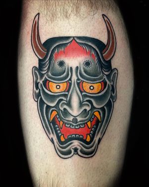 Capture the fierce beauty of the hannya mask with intricate illustration by artist Eddy Ospina on your lower leg.