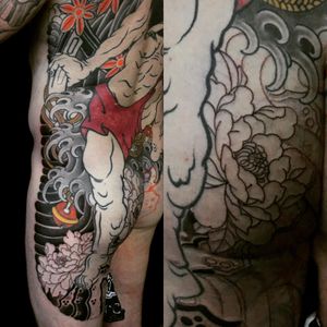Beautiful back tattoo by Ami James featuring a traditional Japanese chrysanthemum flower with swirling waves.