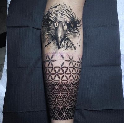 Beautifully detailed blackwork and dotwork tattoo featuring an eagle and ornamental pattern by artist Marcel Oliveira.