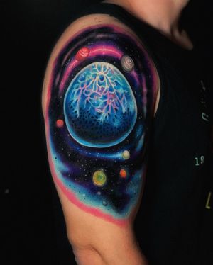 Get lost in the cosmic beauty of this illustrative galaxy and planet tattoo by Marcel Oliveira.