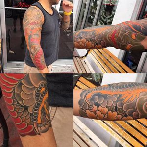 Get a stunning sleeve tattoo featuring a Japanese style dragon and flower, beautifully crafted by Ami James.