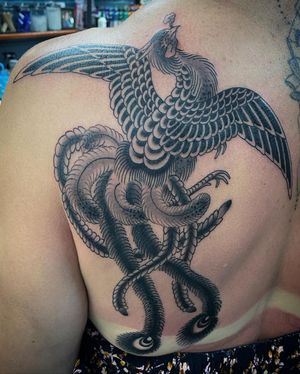 Experience the rebirth and resilience of a phoenix in this stunning blackwork design by Eddy Ospina.