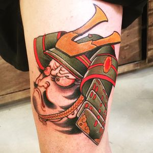 Get a stunning Japanese illustrative tattoo of a samurai man wearing a helmet on your lower leg. Expertly done by renowned artist Ami James.