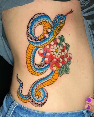 Eddy Ospina masterfully combines a mesmerizing snake with a delicate chrysanthemum in this bold and intricate illustrative design.