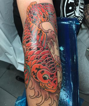 Beautiful koi fish swimming in dynamic waves, expertly done by renowned artist Ami James.