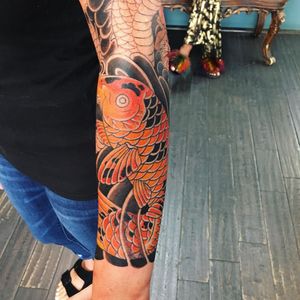 Embrace the beauty of Japanese art with a stunning koi fish tattoo by renowned artist Ami James. Symbolizing perseverance and luck, this piece will surely make a statement on your forearm.