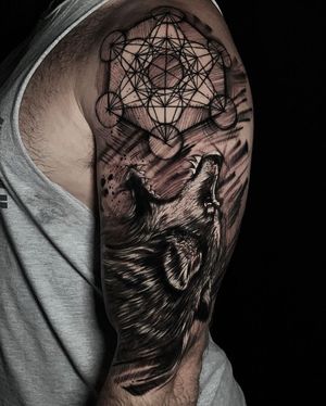 Discover the intricate design of a blackwork wolf surrounded by mesmerizing patterns and mandalas on your upper arm, brought to life by Marcel Oliveira.