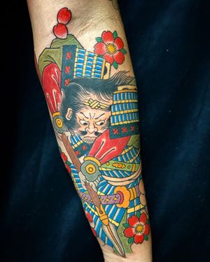 Illustrative forearm tattoo featuring a beautiful composition of sakura, sword, and cherry blossoms by artist Eddy Ospina.