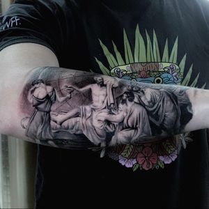 Capture the essence of travel and exploration with this stunning black and gray tattoo of a man holding the world on his forearm by artist Marcel Oliveira.