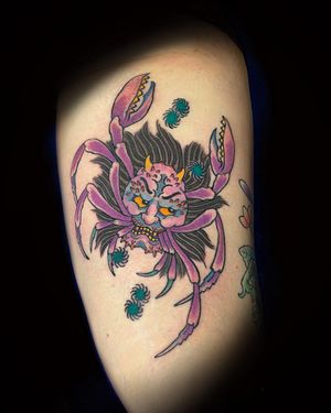 A stunning illustrative tattoo by Eddy Ospina featuring a spider, flower, and crab motif on the upper leg.