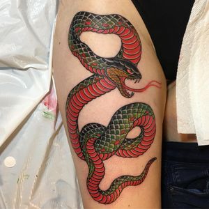 Experience the beauty of Japanese art with this illustrative snake tattoo by renowned artist Ami James. Perfect for those seeking a striking and symbolic piece.