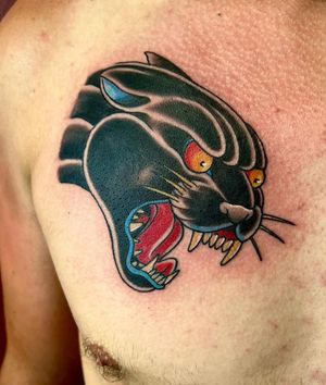Bold blackwork panther design by artist Darren Brass for a timeless look on your chest.