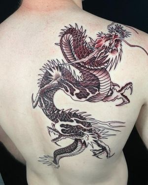 Get a stunning Japanese style dragon tattoo on your back by renowned artist Fernando Joergensen. Embrace the power and beauty of this mythical creature.