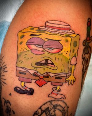 Get a vibrant and playful SpongeBob tattoo on your lower leg in new school illustrative style by Darren Brass.
