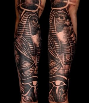 Stunning blackwork forearm tattoo featuring a realistic depiction of the Egyptian god Horus as a bird, by Mauro Imperatori.