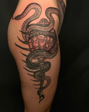 Elegant black and gray snake tattoo on the upper leg by talented artist Fernando Joergensen.