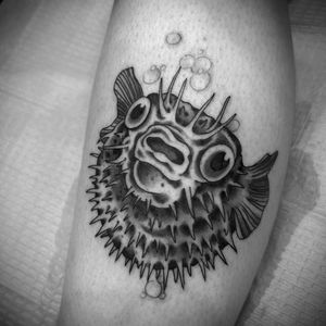 Stunning illustrative lower leg tattoo of a fish by renowned artist Darren Brass, showcasing intricate blackwork details.