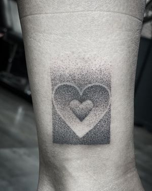 Illustrative ankle tattoo by Rico Dionichi featuring a unique heart and pattern design created using dotwork technique.