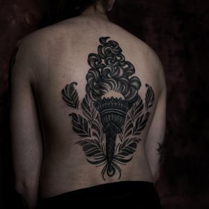 Embrace the flames with this intricate blackwork and dotwork design by renowned artist Lamat. Perfect for those seeking a unique and mesmerizing back piece.
