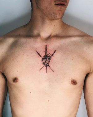 Discover the powerful symbolism of a heart pierced by a sword in this stunning black and gray chest tattoo by Gabriele Edu.