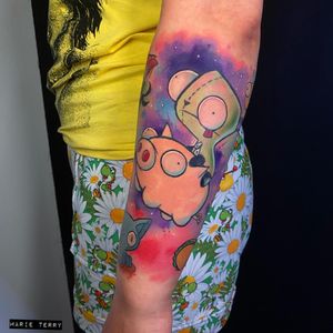 Vibrant new_school watercolor forearm tattoo featuring a playful dog and pig, by tattoo artist Marie Terry.