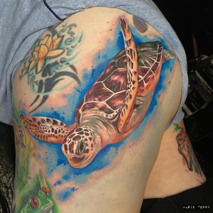 Experience the beauty of the sea with this stunning new school tattoo by Marie Terry. Dive into the world of realism and stand out with this unique design.
