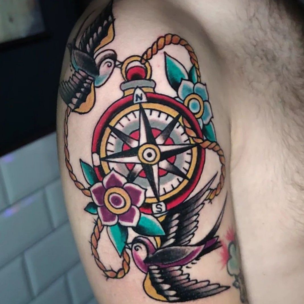 A compass tattoo surrounded by vibrant roses and fishing hooks    Arthubai