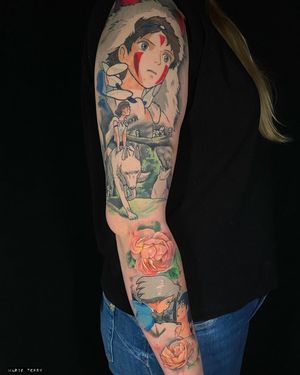 Vibrant anime-style sleeve tattoo featuring a dog and man, beautifully crafted by Marie Terry. Perfect for those who love unique and colorful designs.
