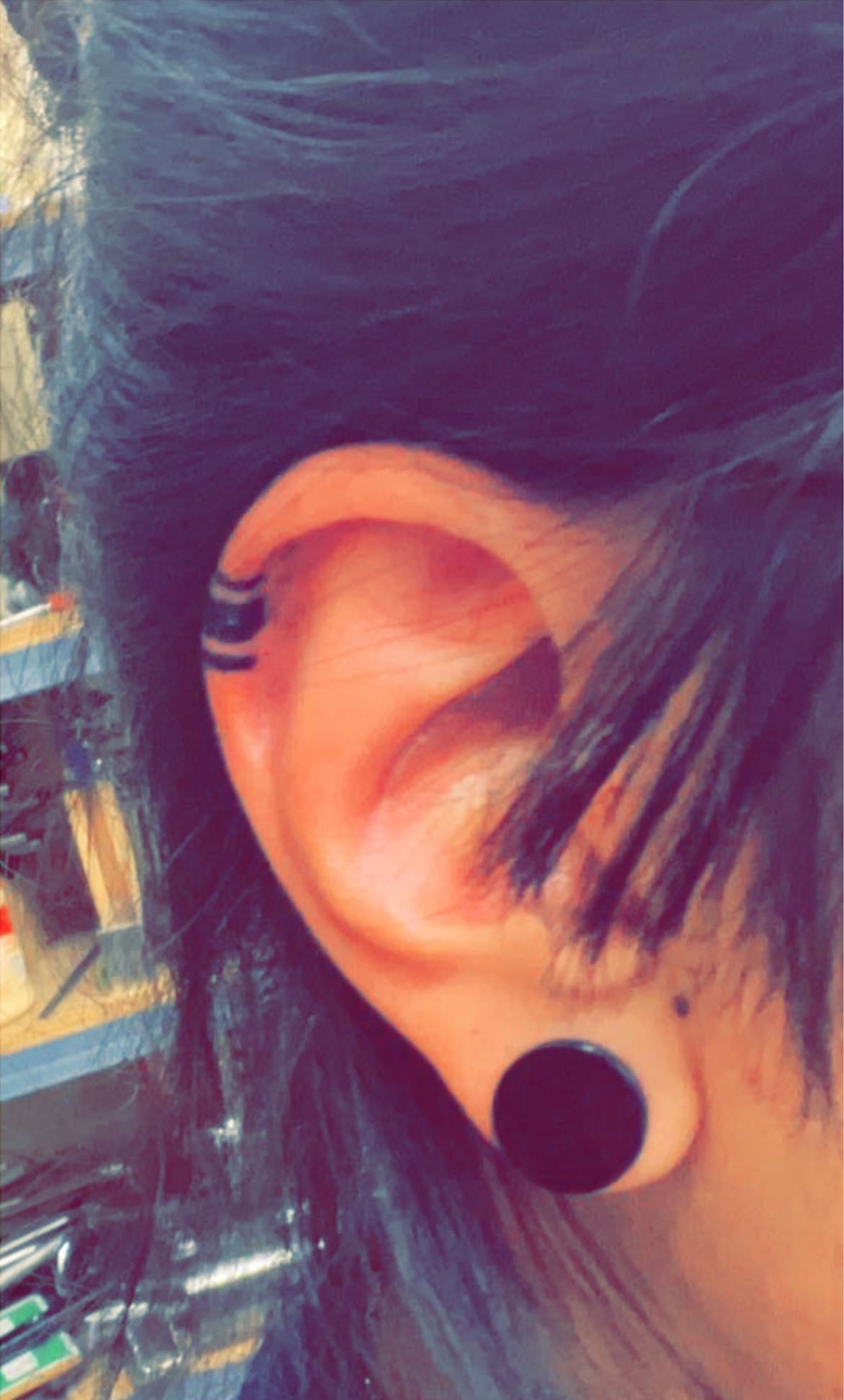 Black Tribal Seahorse Tattoo On Women Right Behind The Ear