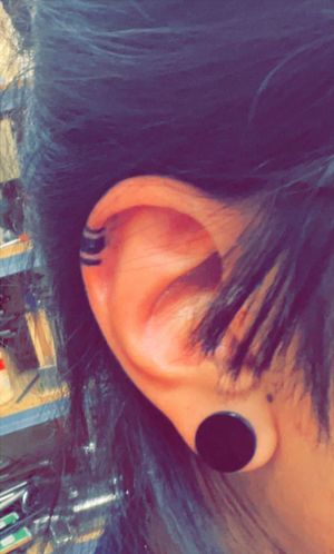 Hispanic tribal ear line tattoo! The three lines represent the Aztec, Mayan, and Incan culture. The thickest line is Myan which is a part of my ancestry. The lines are also geographically in order of where each civilization lived according to the globe.