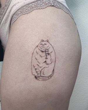 Illustrative upper leg tattoo by Anna featuring a cat and a glass motif in fine line style.