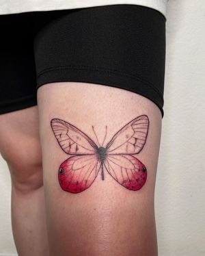 Anna's beautiful illustrative butterfly tattoo elegantly placed on the upper leg, creating a stunning and captivating look.