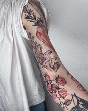 Get a stunning illustrative blackwork tattoo featuring a flower and mushroom design on your upper arm, expertly done by Anna.