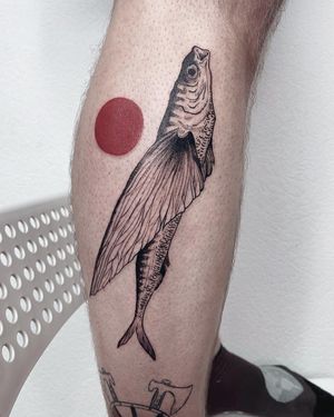 Explore the depths of blackwork and illustrative styles with this stunning sun and fish tattoo by Anna on your lower leg.
