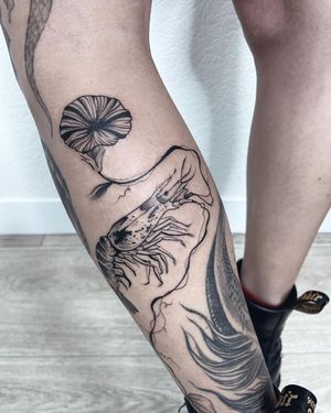 Illustrative lower leg tattoo featuring a beautiful flower and shrimp, created by Anna.