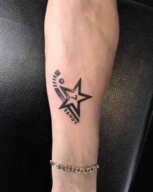 Intricate blackwork tattoo on forearm by Lim featuring a star, name, and number in illustrative lettering.