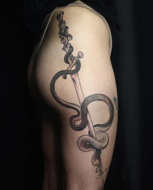 Impressive blackwork snake intertwining with a sword, masterfully illustrated by Slava on the upper leg.