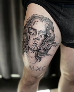 A stunning upper leg tattoo featuring a captivating illustration of Medusa and a snake, expertly done by Slava.