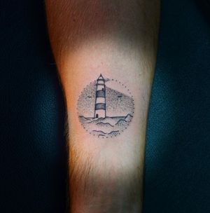 Adorn your forearm with Lim's breathtaking blackwork and dotwork lighthouse design, a beacon of strength and hope.