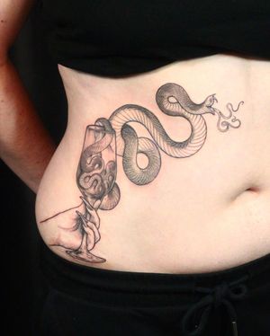 Blackwork design featuring a snake, glass, and hand motif, expertly done by Slava. Perfect for those who love detailed and unique tattoos.