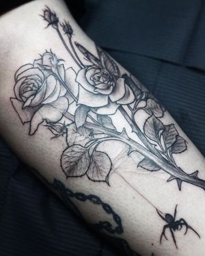 Elegant forearm tattoo featuring a blackwork style flower, expertly done by Slava.