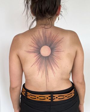 Get mesmerized by this blackwork upper back tattoo featuring a fine line geometric sun pattern, expertly done by artist Slava.