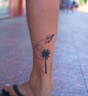 Unique blackwork tattoo featuring a tree made of origami cranes and an airplane on the ankle. Created by talented artist Lim in a fine line illustrative style.