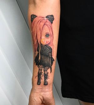Vibrant new school tattoo on forearm features a cute girl with bubble gum and candy motifs, done by artist Lim