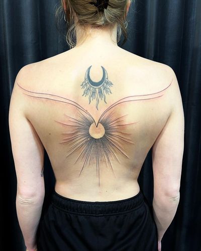 Experience the beauty of fine line blackwork with this intricate geometric sun and pattern design on your back.