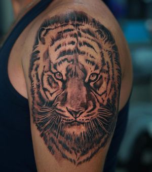 Get inked with a fierce blackwork tiger design by artist Lim. Bold and captivating, this tattoo is sure to make a statement.