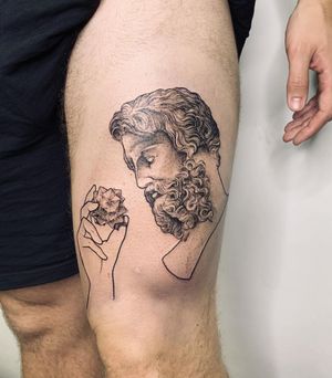 Unique blackwork tattoo by Slava on upper leg, featuring an illustrative style man with a detailed patterned beard design.