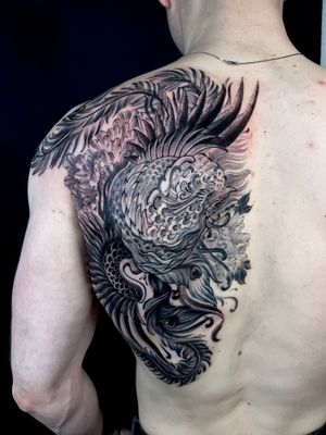 Illustrative tattoo featuring a fish, flower, and chrysanthemum, beautifully executed by Kiko Lopes on the back.